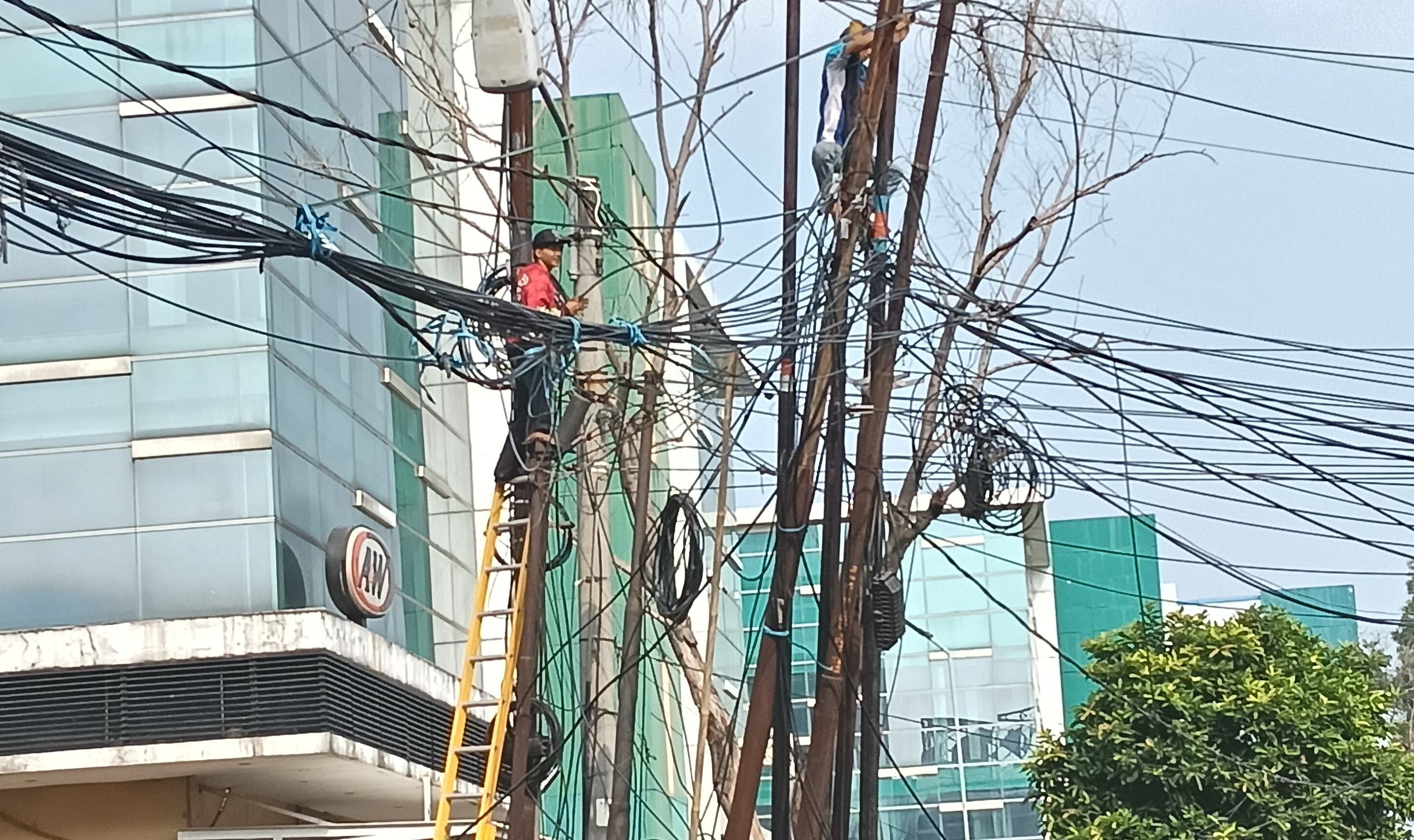 Kabel Fiber Optik Berantakan Ganggu Jalan KHR Ma'mun Nawawi
